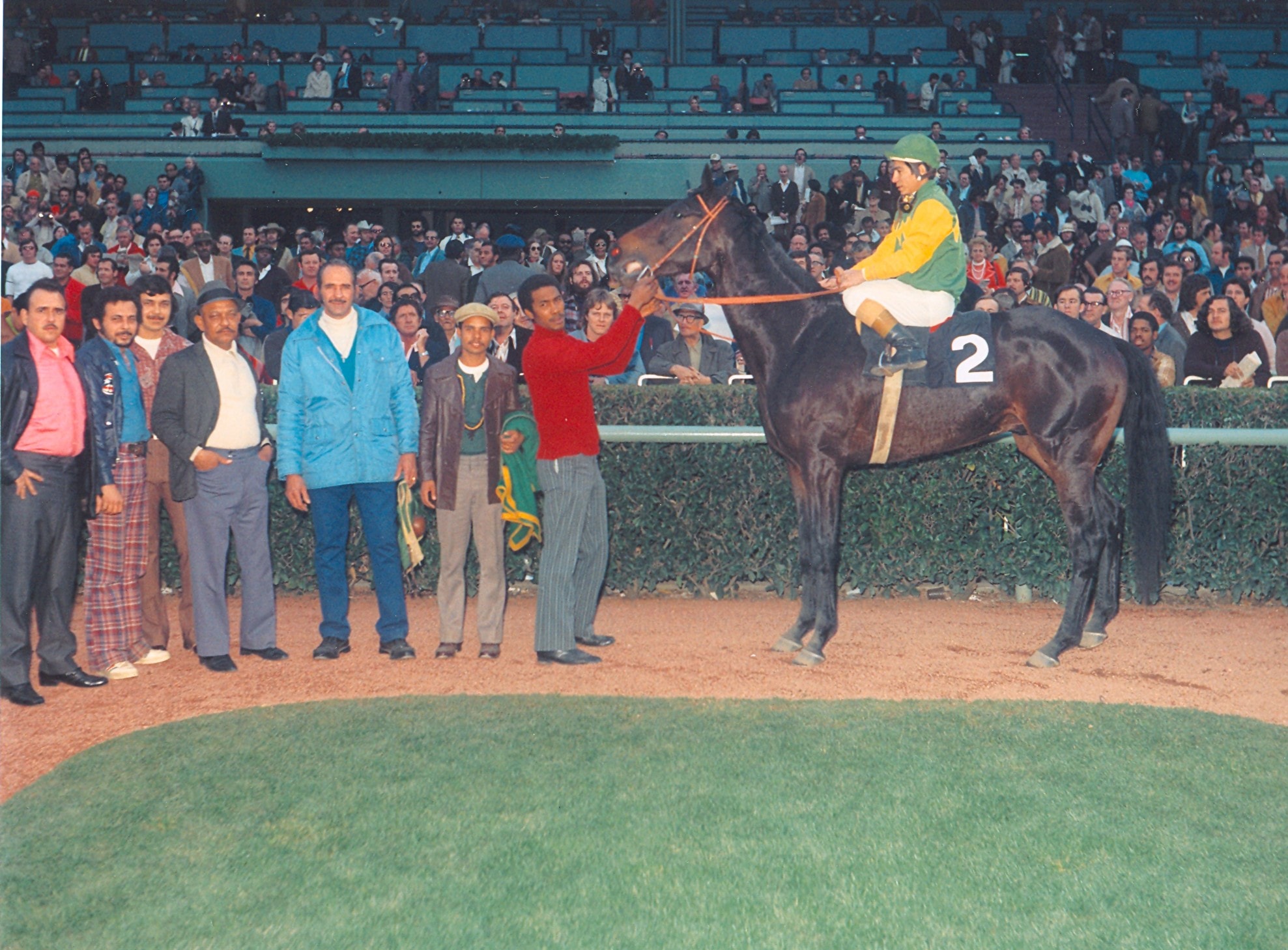 Jockey Laffit Pincay, Jr. and Sham's groom, Secundino Gato, are all smiles as they pose for photographs in the winner's circle February 2, 1973. © George Andrus, photographer.